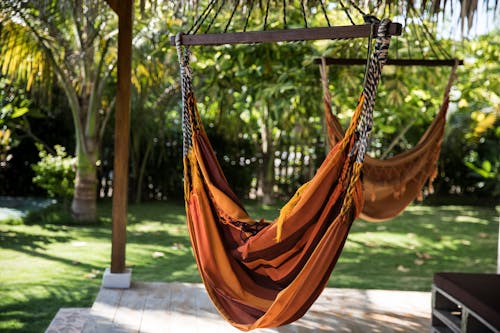 Brown Hammock Hanged on Brown Wooden Frame