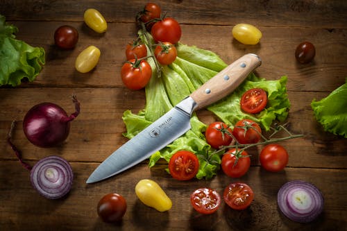 A Kitchen Knife and a Variety of Fruits and Vegetables
