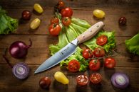 A Kitchen Knife and a Variety of Fruits and Vegetables
