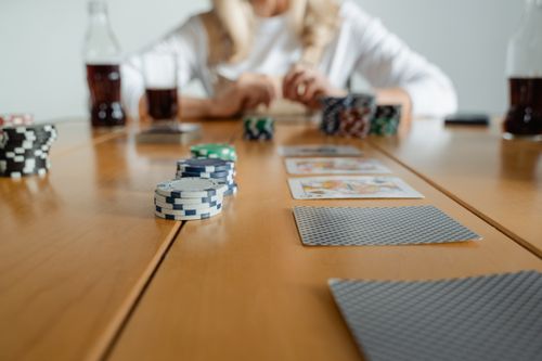 Free Close-up of poker chips and cards on a table during a casual game session indoors. Stock Photo