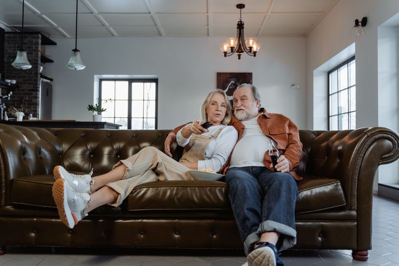 A senior couple relaxing together on the sofa in their home