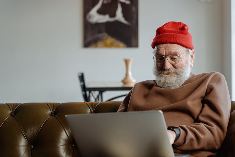 An Elderly Man Using A Laptop