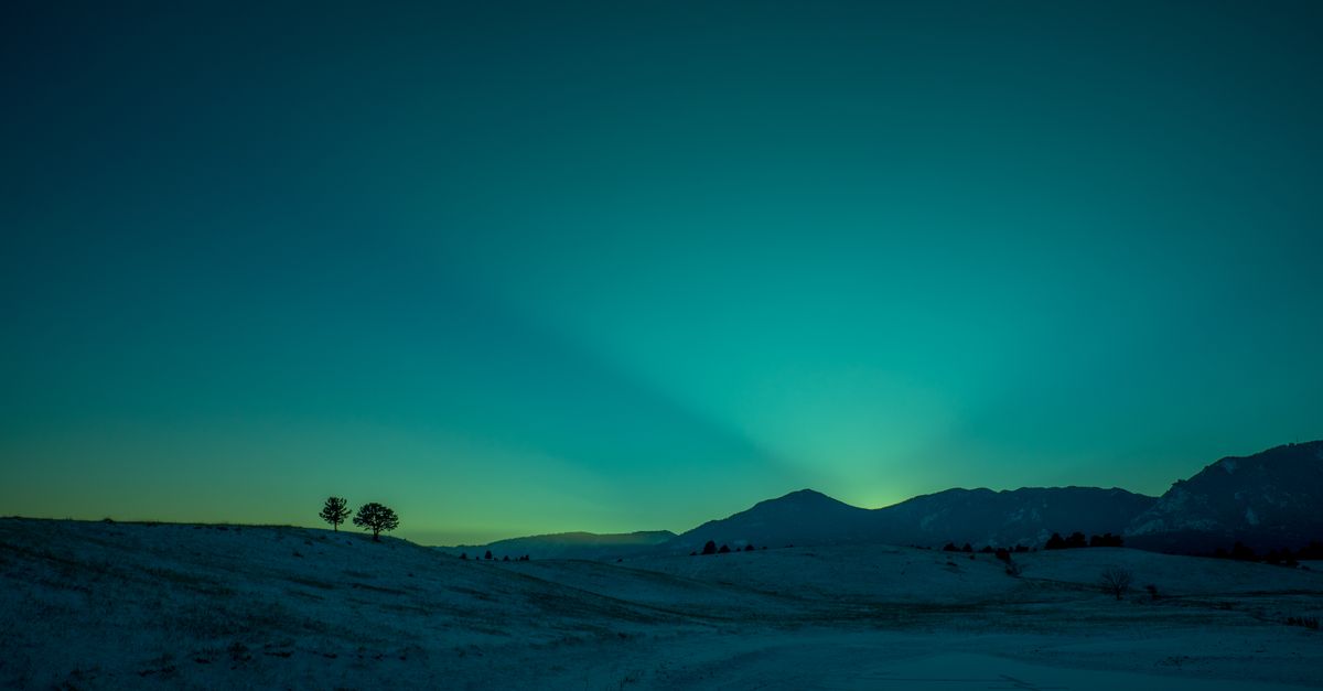 Serene twilight over snowy Boulder landscape, capturing the magical winter ambiance.