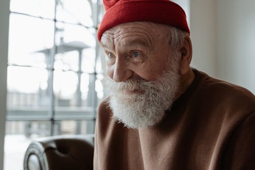 Man In Brown Sweater and Red Beanie