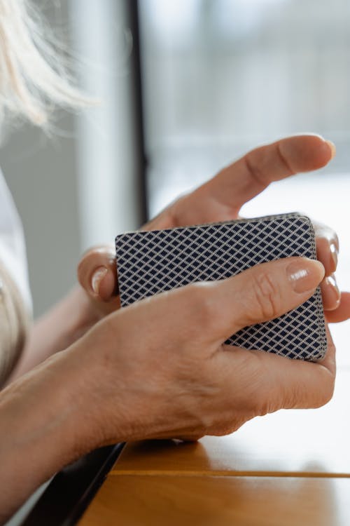 Person Holding Playing Cards