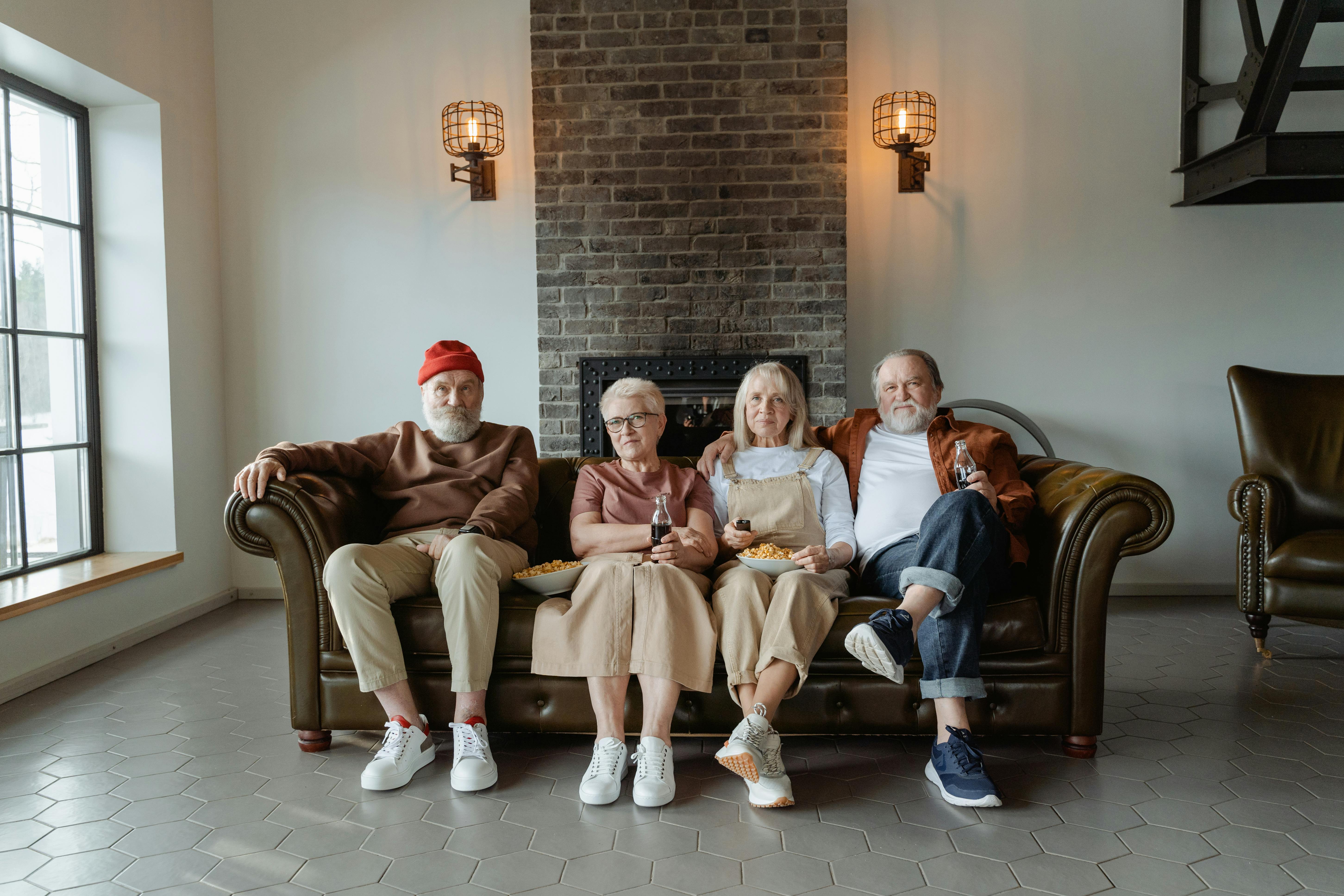 people sitting on brown leather sofa