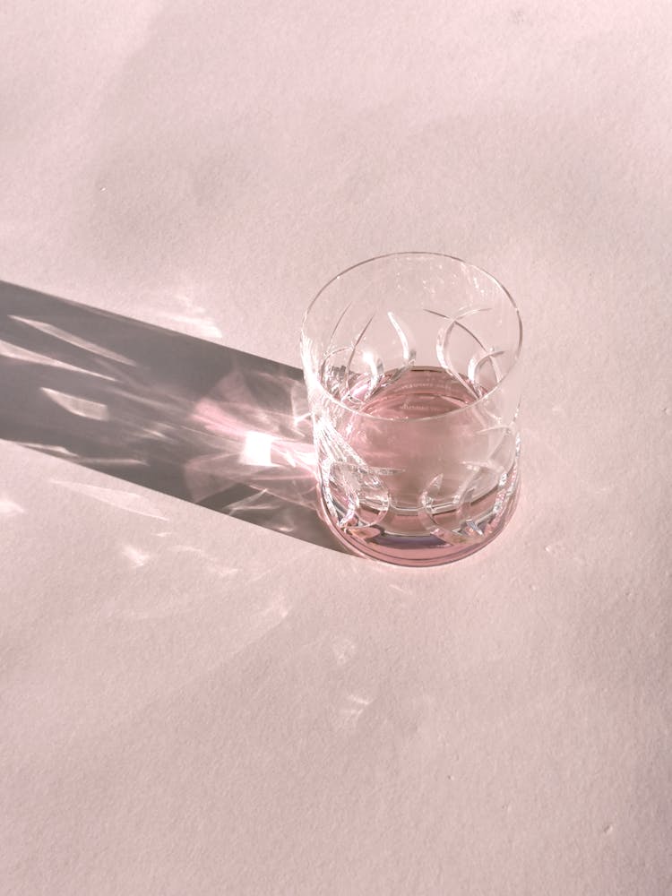 Crystal Cup With Wine On Pink Table