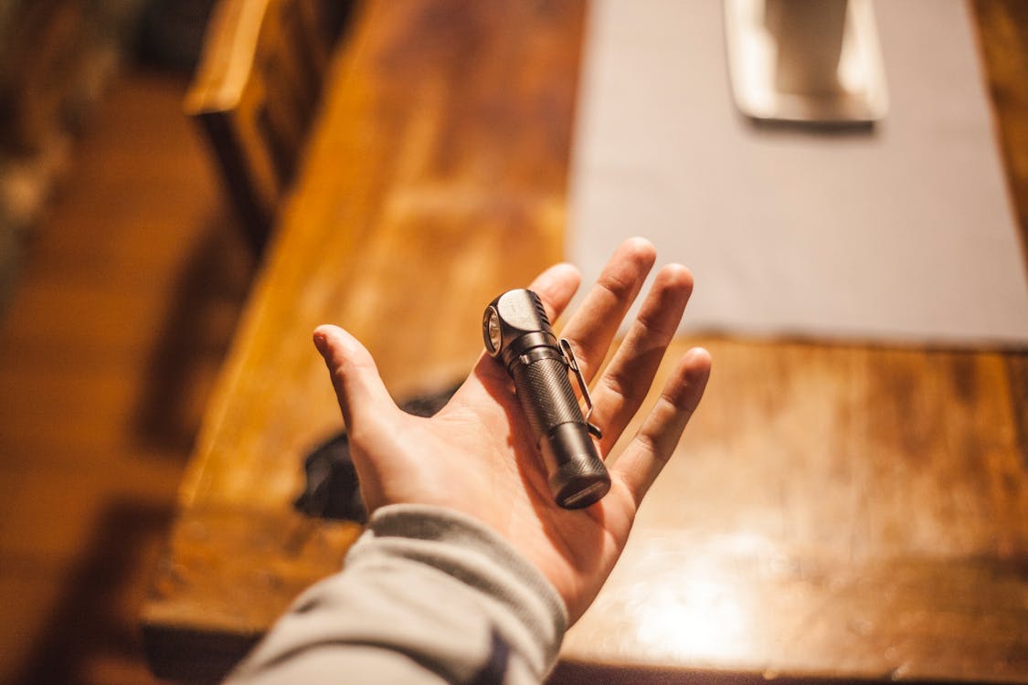 person holding a flashlight in their hand