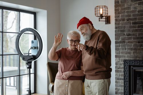 Free Happy senior couple engaging with technology at home, capturing memories. Stock Photo