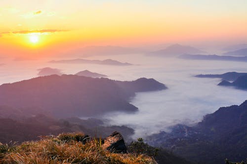 Free Sun Rise With Mountain and Green Grass Stock Photo