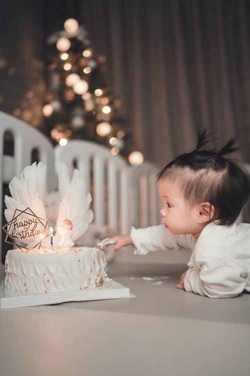 Free A Young Girl Touching a Birthday Cake Stock Photo