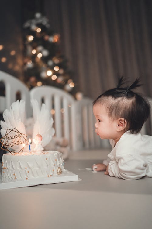 Free A Child Looking at a Birthday Cake Stock Photo