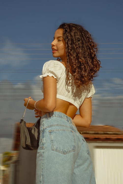Free A Pretty Curly-Haired Woman in White Crop Top  Stock Photo