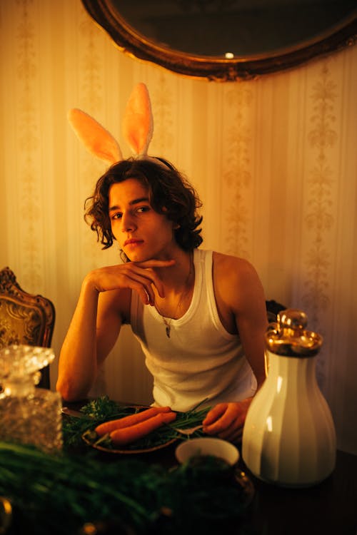 Model Posing in Bunny Ears over Plate with Carrots