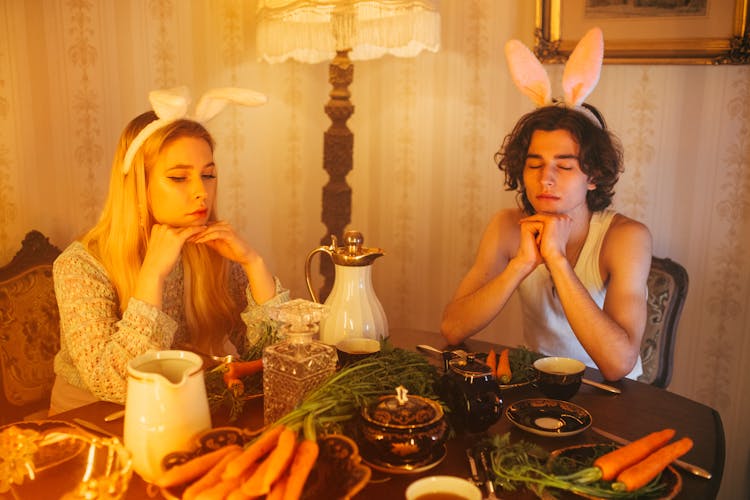 A Couple Wearing Bunny Ear Headbands Dining