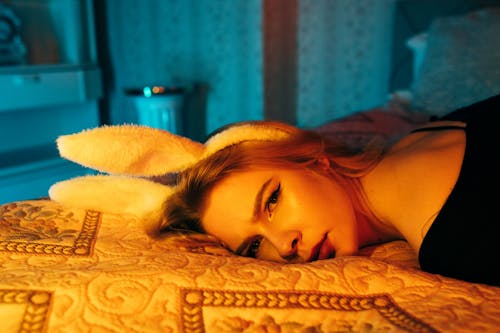 Close-up Shot of Woman in Bunny Headband Lying on Bed