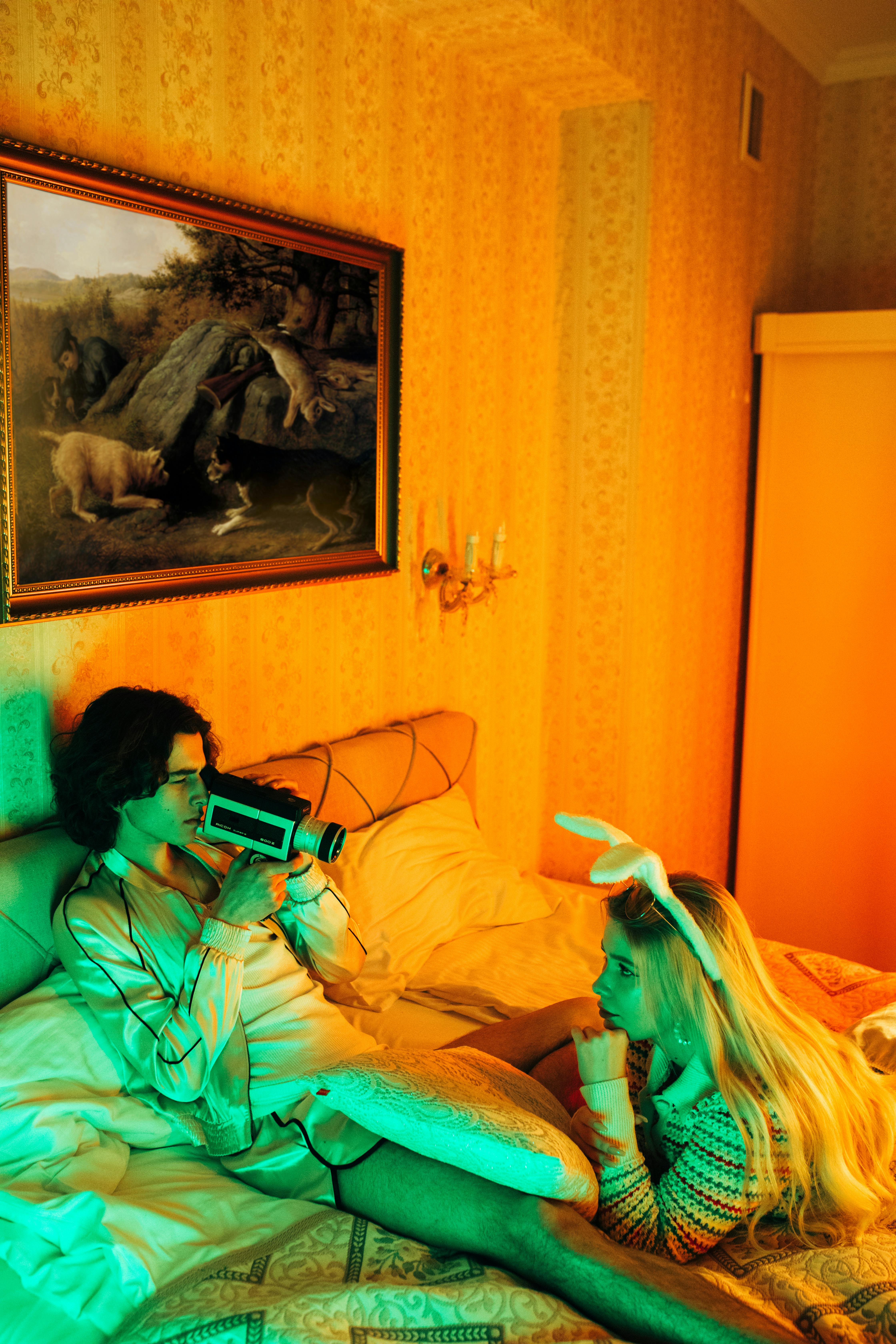 woman in green and white dress sitting on bed