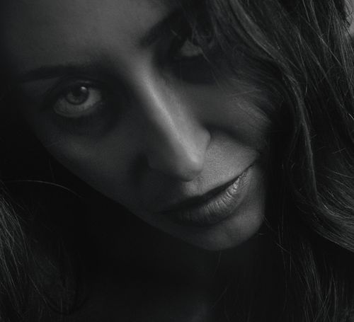 Free Close-up black and white portrait capturing an intense expression of a woman. Stock Photo