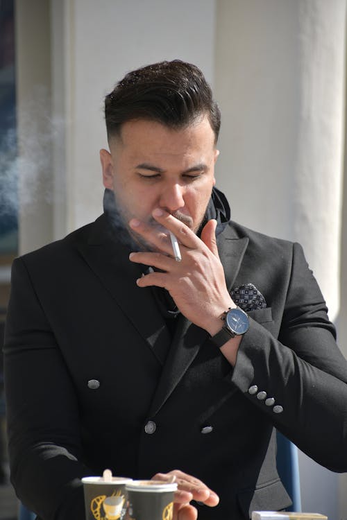 Free Man in Black Suit Jacket Smoking Cigarette Stock Photo