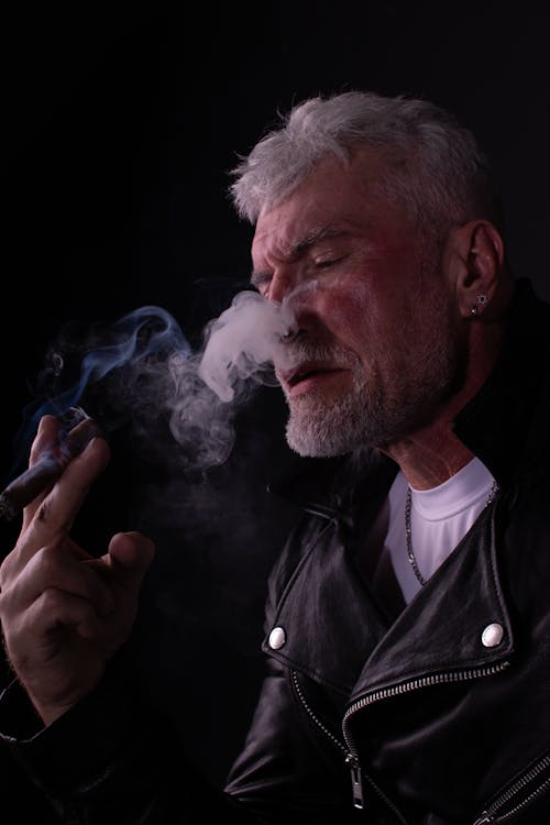 Free Close-Up Shot of an Elderly Man in Black Leather Jacket Smoking Stock Photo