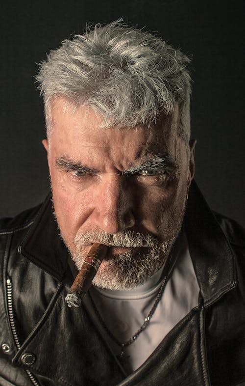 Portrait of an Elderly Man in Black Leather Jacket Smoking