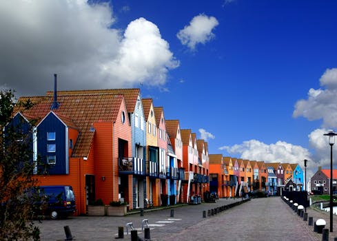 Vibrant row houses under a bright blue sky in Stavoren, highlighting Dutch urban architecture.