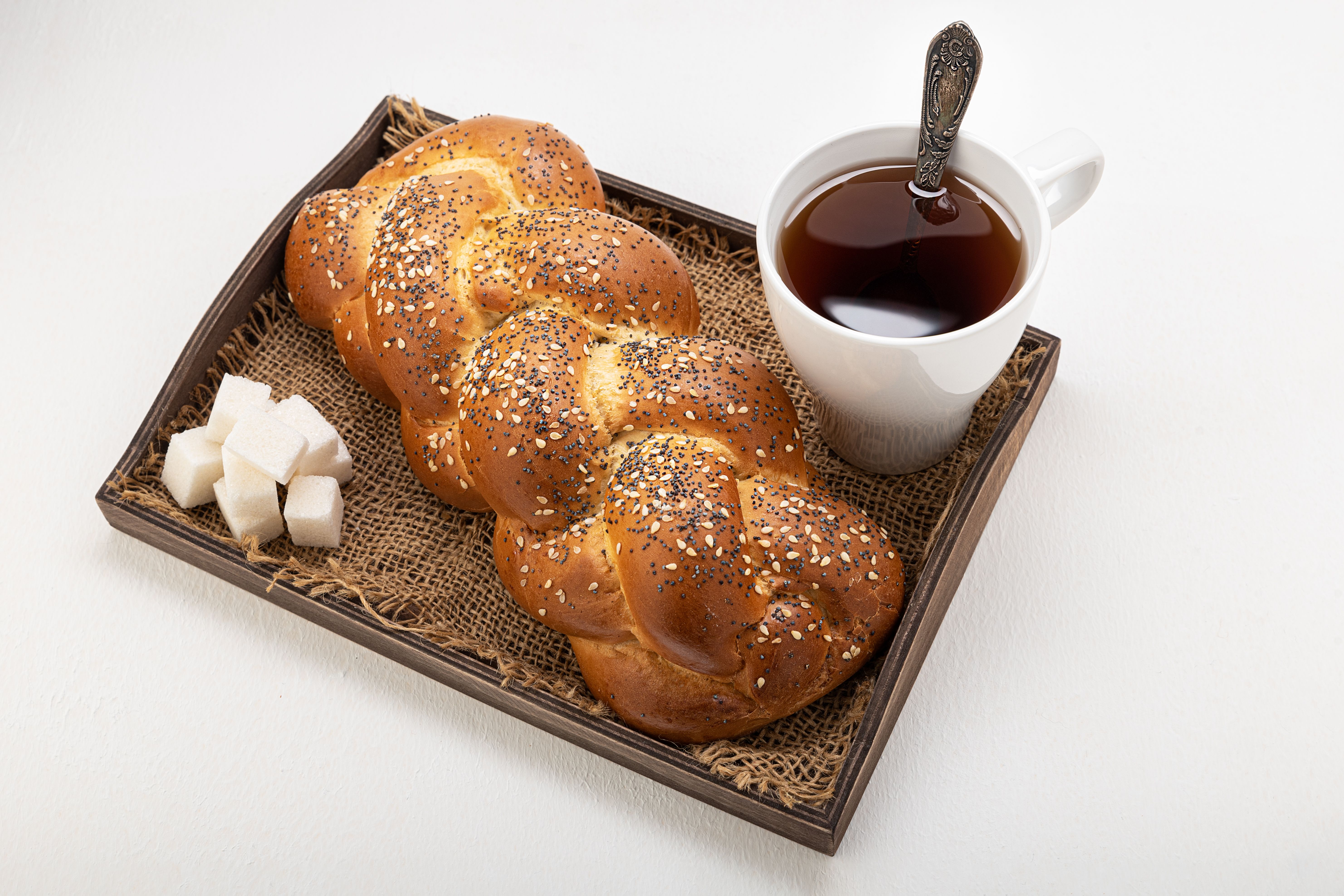 Creamy raspberry filling spread on challah dough