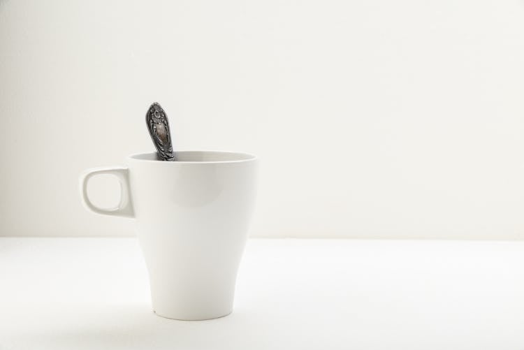 White Mug With Old Silver Teaspoon 