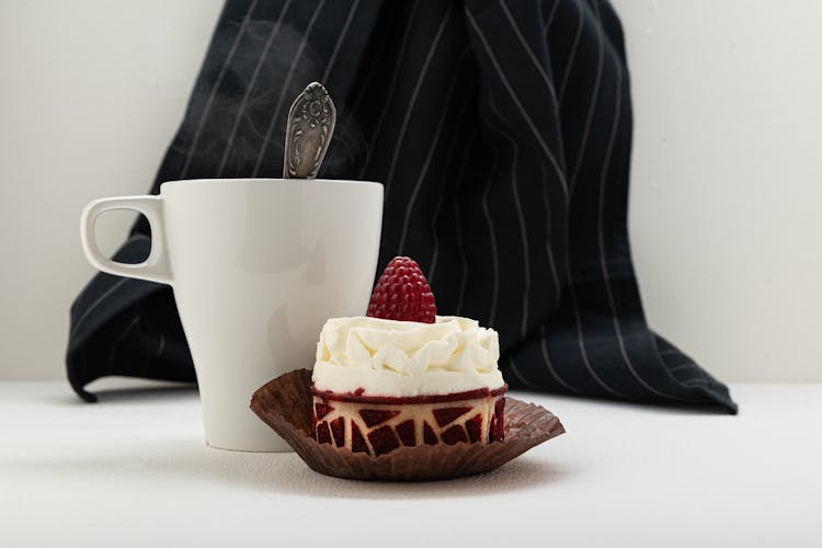 Single Serve Raspberry Cake With Steaming Cup Of Coffee