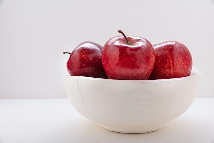 Ripe Red Apples In Bowl On White Background