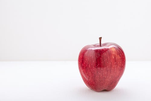 Red Apple on White Surface