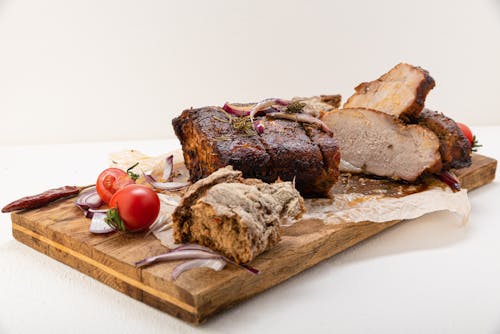 Free Roasted Meat over a Wooden Tray Stock Photo