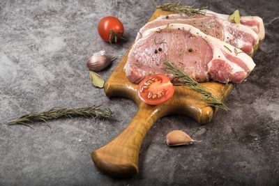 Raw bone-in pork chops with rosemary — photo by Evgeniy Alekseyev on Pexels