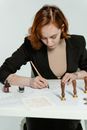 Woman in Black Blazer Writing on White Paper