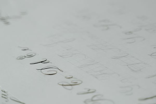 Cursive lettering practice sheet — photo by MART PRODUCTION on Pexels