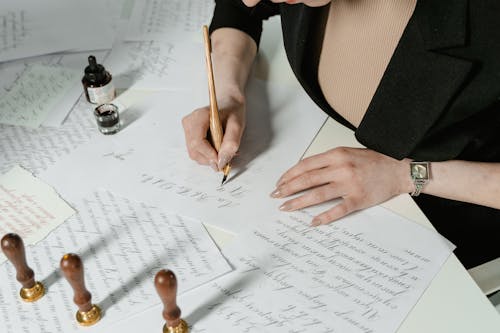 Free A Woman Writing on a Paper Stock Photo