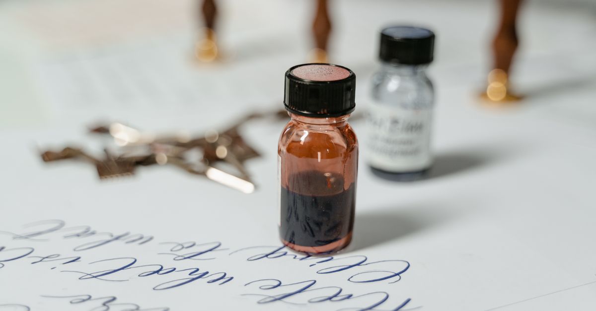 Elegant close-up of ink bottles with calligraphy script on paper, ideal for creative themes.