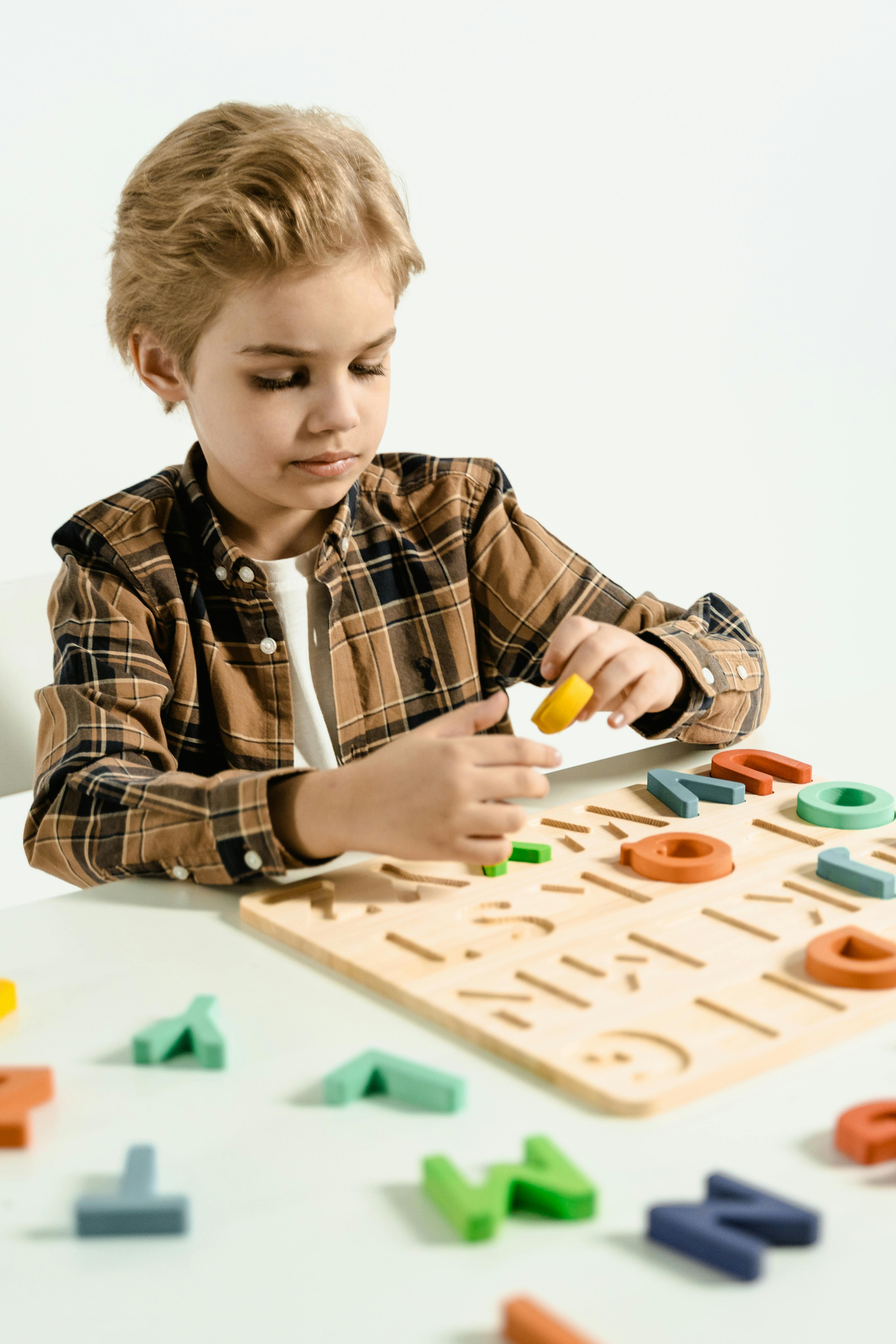 a boy playing with an educational toy