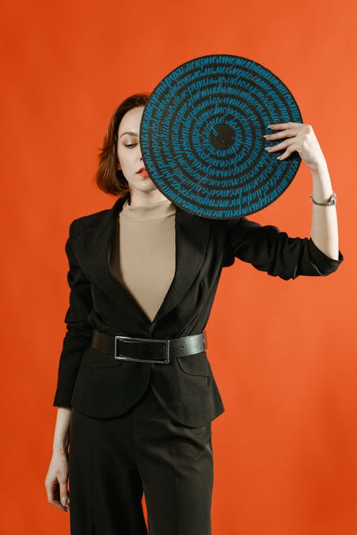 Woman in Black Blazer Holding Hand Fan