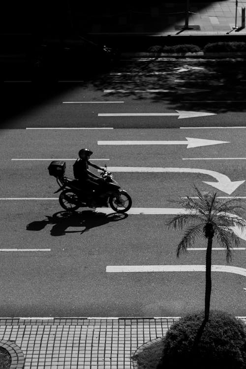Free Grayscale Photo of Man Riding Motorcycle on Road Stock Photo