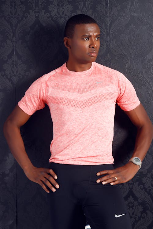Free Man Wearing Pink Crewneck Shirt and Black Nike Shorts Standing Stock Photo