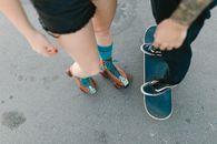 Person in Blue and Orange Nike Sneakers