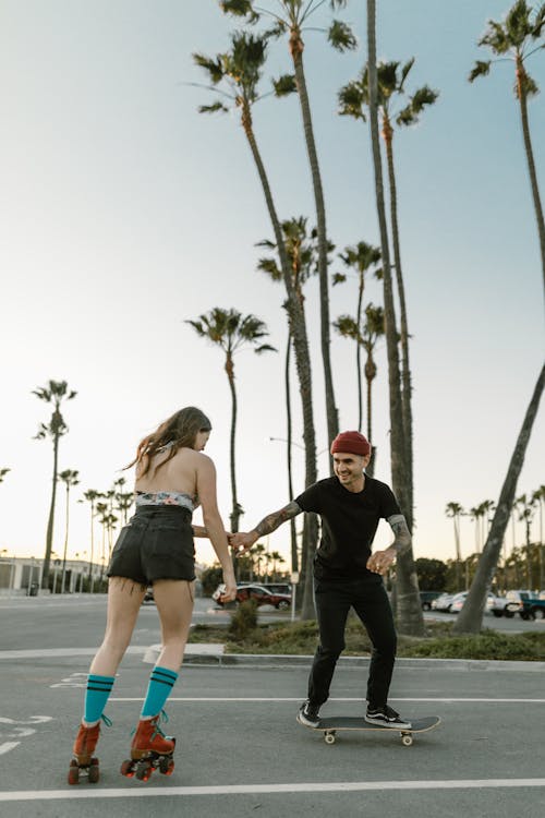 Free Couple using Skating Devices  Stock Photo