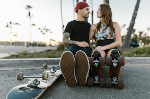 A Couple with Roller Skates and Skateboard