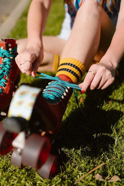 Person tying Shoelaces on a Rollerskate