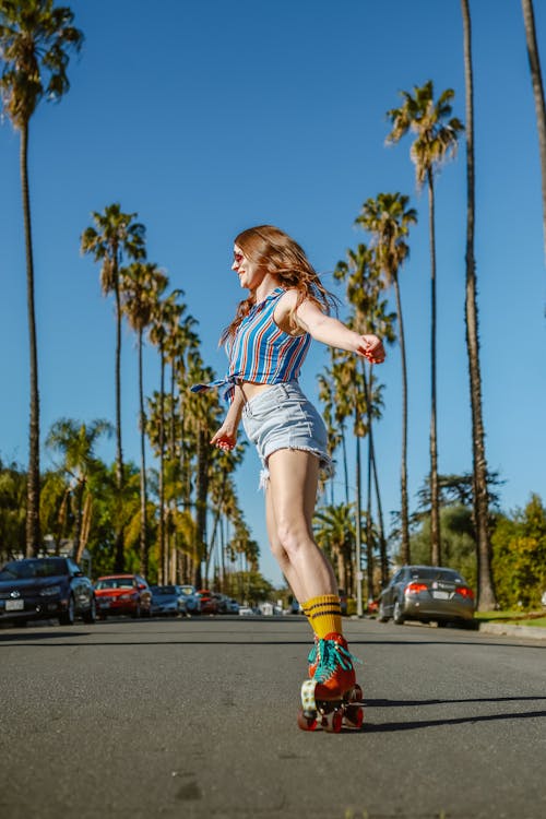 A Woman Roller Skating on a Road 