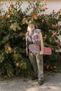 Man in Brown Pants Standing Near Green Christmas Tree