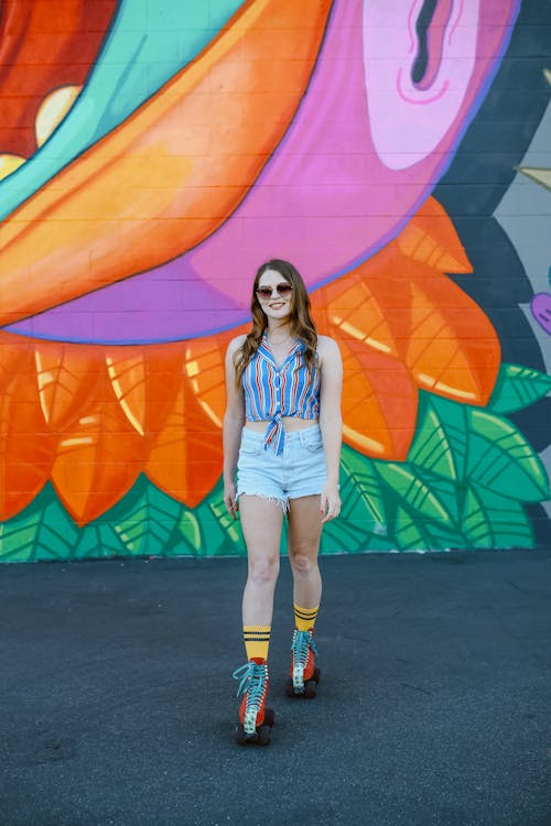 Woman Roller Skating Near Colorful Street Art