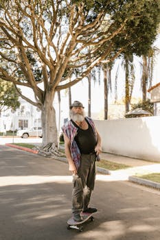 Senior man skateboarding down a sunlit street, embracing an active lifestyle.