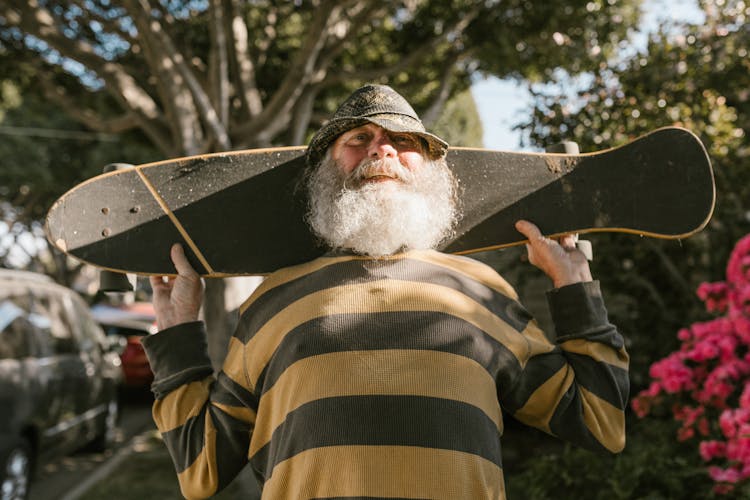 Bearded Man Holding A Skateboard